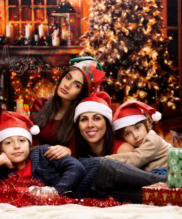a family posing for a photo in front of a christmas tree