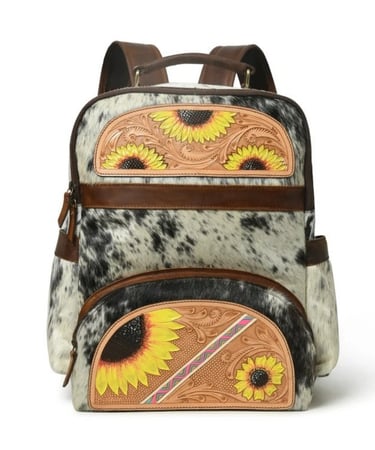 Western cowhide leather backpack featuring hand-tooled floral sunflowers and a black and white fur design.