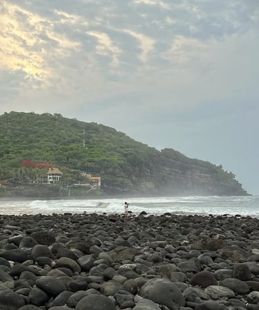 camera man taking pictures at rocky beach