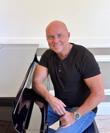 Composer Mark Bulmer Sitting at Piano