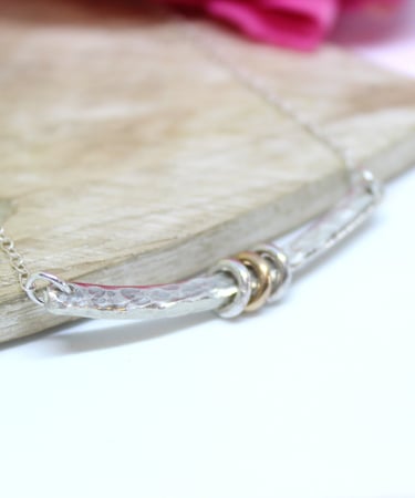 Silver handmade necklace with a bar and 2 silver and 1 gold ring for a 21st birthday. 