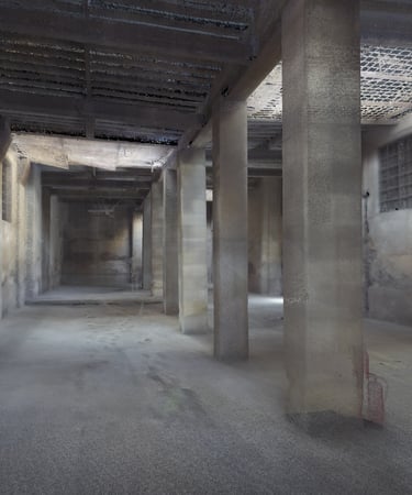 A detailed 3D point cloud scan of an empty industrial warehouse interior with concrete pillars.