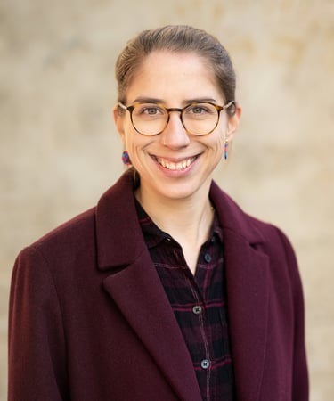 a woman in glasses and a red jacket