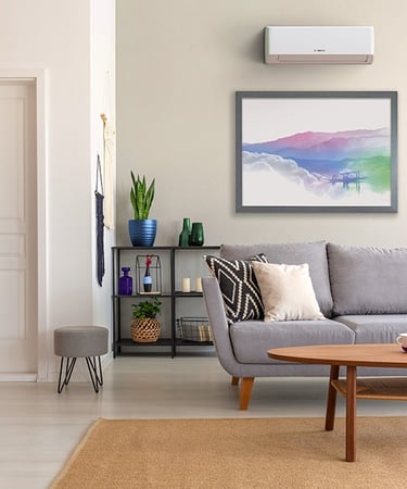 Modern living room featuring a grey sofa, wooden coffee table, and a wall-mounted Bosch air conditioner.