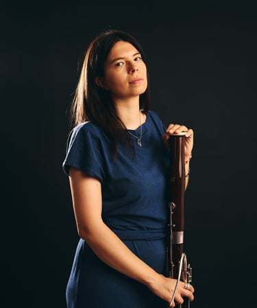 a woman in a blue dress holding a trumpet
