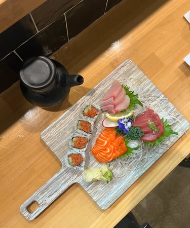 a wooden cutting board with sushi and sushi