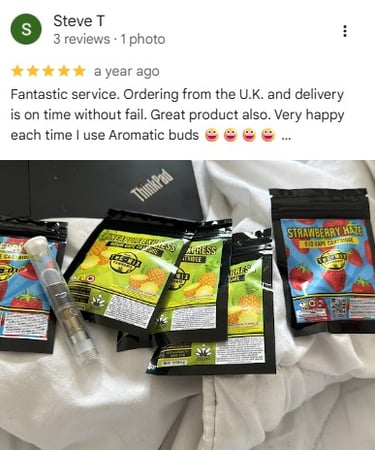 Customer review photo showing Strawberry Haze and Pineapple Express vape cartridges from Aromatic Buds.