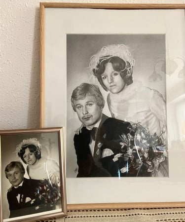 an small old wedding picture sitting next to a pencil drawing of the same picture