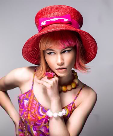 a woman with a red hat and a pink dress