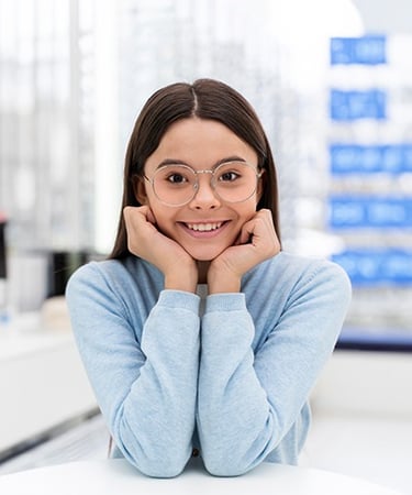 a woman in glasses and a blue sweater
