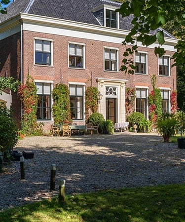 a large house with a large driveway and a gravel path