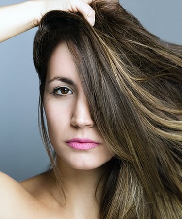 a woman with long hair and a pink lipstick