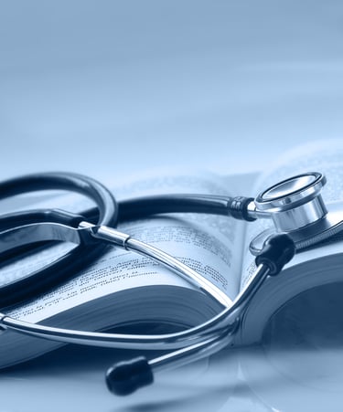 An open medical book with a stethoscope on top of it