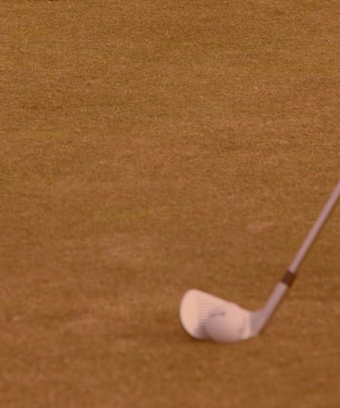 A FlightScope launch monitor being used during a golf lesson on a grassy course in Aberdeen with club positioned for a swing