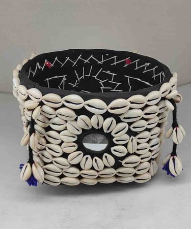 "Bamboo basket wrapped in elegant black fabric with tribal-style shell detailing and floral garland-Export-oriented"