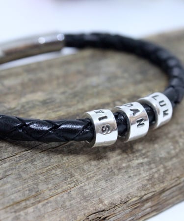 A silver name bead for each family member on a gents leather bracelet
