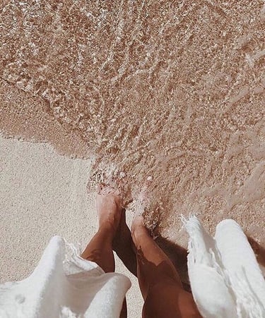 a brides footsteps in sand