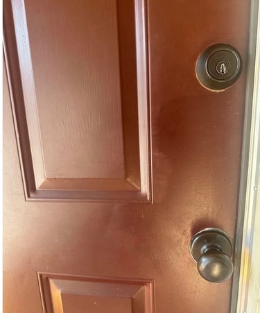 Red home door with deadbolt and knob representing residential locksmith services Candler, NC 