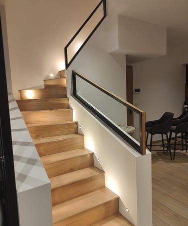 a staircase in oak with a steel and oak railing in a contemporary style