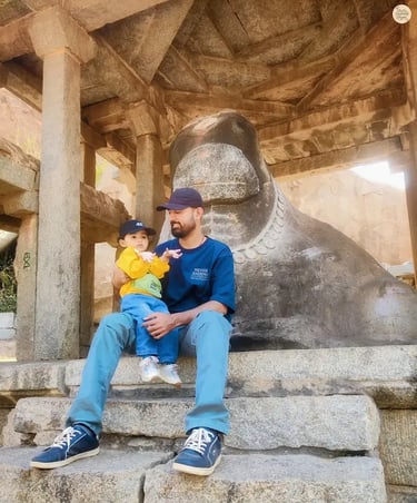 Parent with child at Big Nandi, the guardian statue of Hampi.