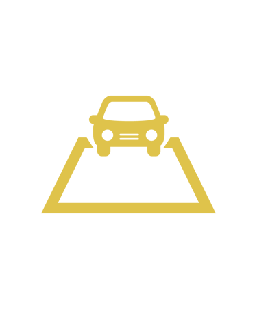 a car driving down a hill with a car in the background