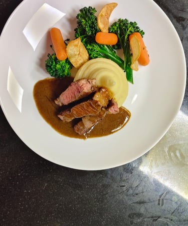 Professional Plating of a Rib Eye Steak with mashed potato and side vegs made at Upskill Hospitality