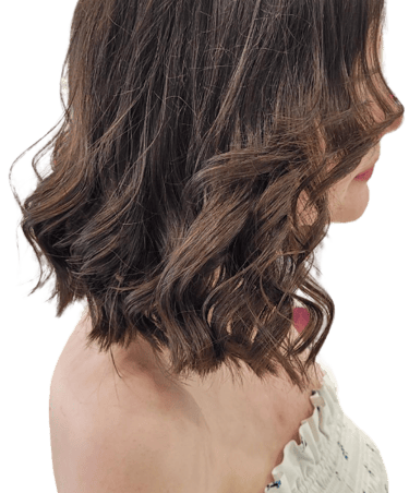 Woman with soft, layered haircut and blow-dry finish