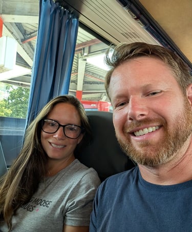 Moose and Bugs taking a selfie while sitting together on a passenger bus during a trip.