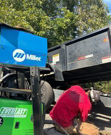 a man welding a heavy trailer