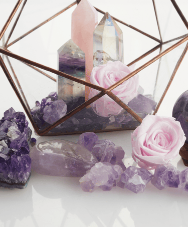 a glass box with a candle and a candle holder