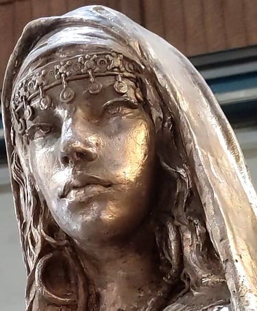 Bronze sculpture of a Muslim princess with traditional headdress and veil.