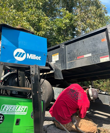 a man welding a heavy trailer