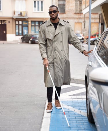 man with glaucoma wearing glare shields crossing street with cane for the blind independently