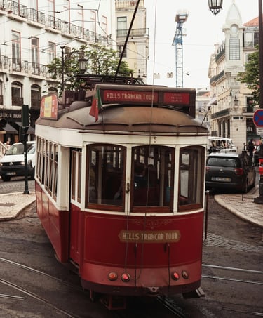 Historic tram moving through narrow streets in Lisbon, Portugal