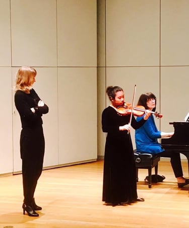 Violin teacher with her student practicing for a concert