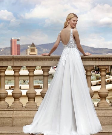 a woman in a white dress standing on a balcony