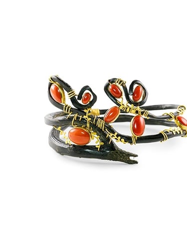 a pair of rings with red and black enamel