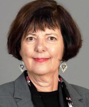 a woman in a gray suit and black tie