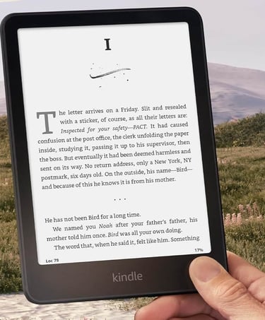 Woman enjoying a Kindle e‑reader while relaxing outdoors..