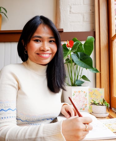 New York City Calligrapher smiling and holding a nib and pen holder