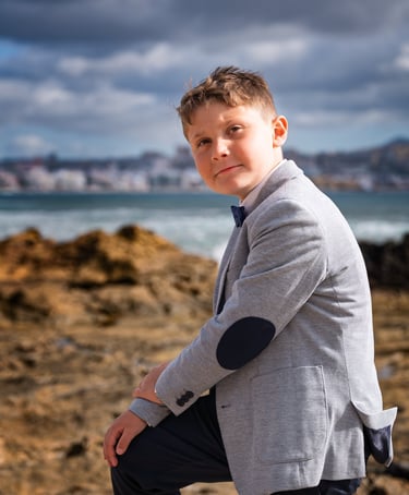 a young boy in a suit and tie