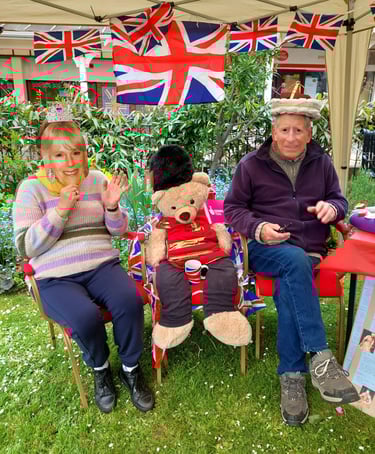 a man and woman sitting on chairs in a garden