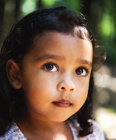 Young girl with selective mutism looks upwards.