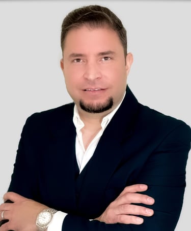a man in a suit and white shirt and wearing a watch