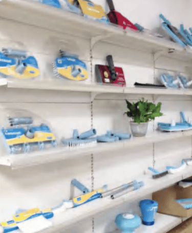 pool equipment company brushes on shelves