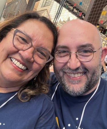 a man and woman smiling and posing for a picture