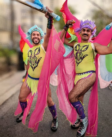 two men in colorful costumes are dancing in the street