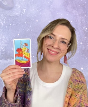 Natalie holding the Knight of Wands tarot card for a Crystal Aura Tarot reading lesson