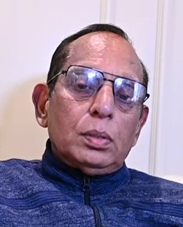 Customer : a man in a blue jacket and glasses named Chandok Ji  