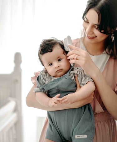 Mother holding baby near window – Fred Art Studio family session